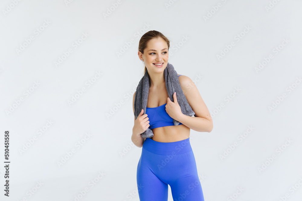 Fitness woman with a towel isolated on a white background