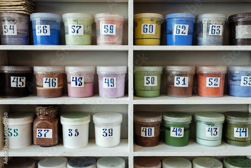 Jars with paints on the shelves