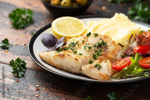 Obraz na plátně Fried cod loin fillet with mashed potato and vegetable salad served with fresh l