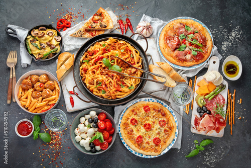 Italian food assortment on dark background. photo