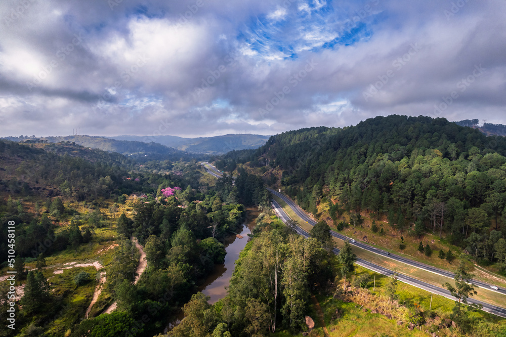 Obraz premium Aerial view of the Dom Pedro Highway in the city of Campinas. Road with lots of vegetation, trees and nature.