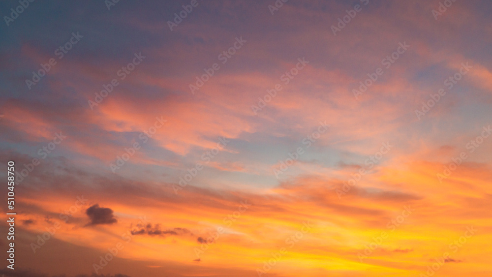 Dramatic sunset sky with evening sky clouds lit by bright sunlight