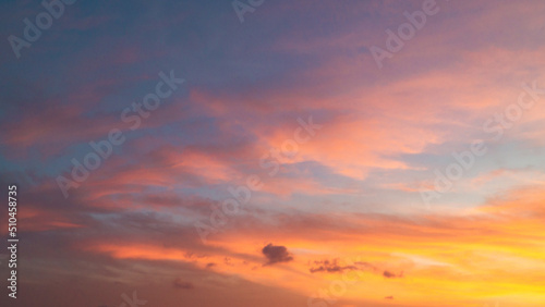 Dramatic sunset sky with evening sky clouds lit by bright sunlight
