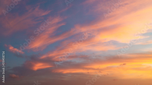 Dramatic sunset sky with evening sky clouds lit by bright sunlight