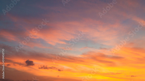 Dramatic sunset sky with evening sky clouds lit by bright sunlight