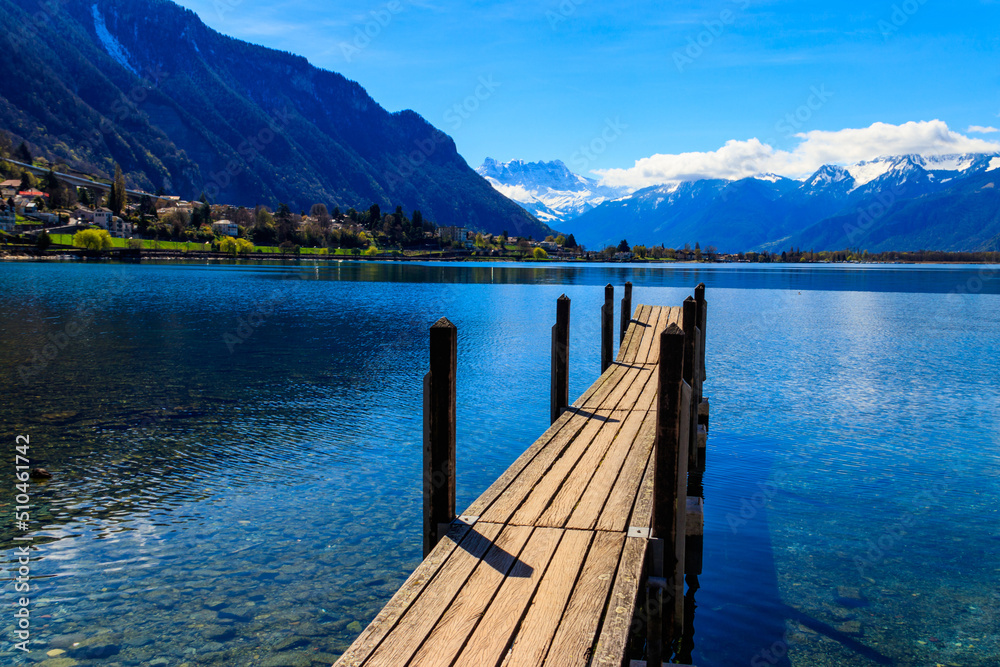 Wooden pier overlooking the Alps and Lake Geneva in Switzerland