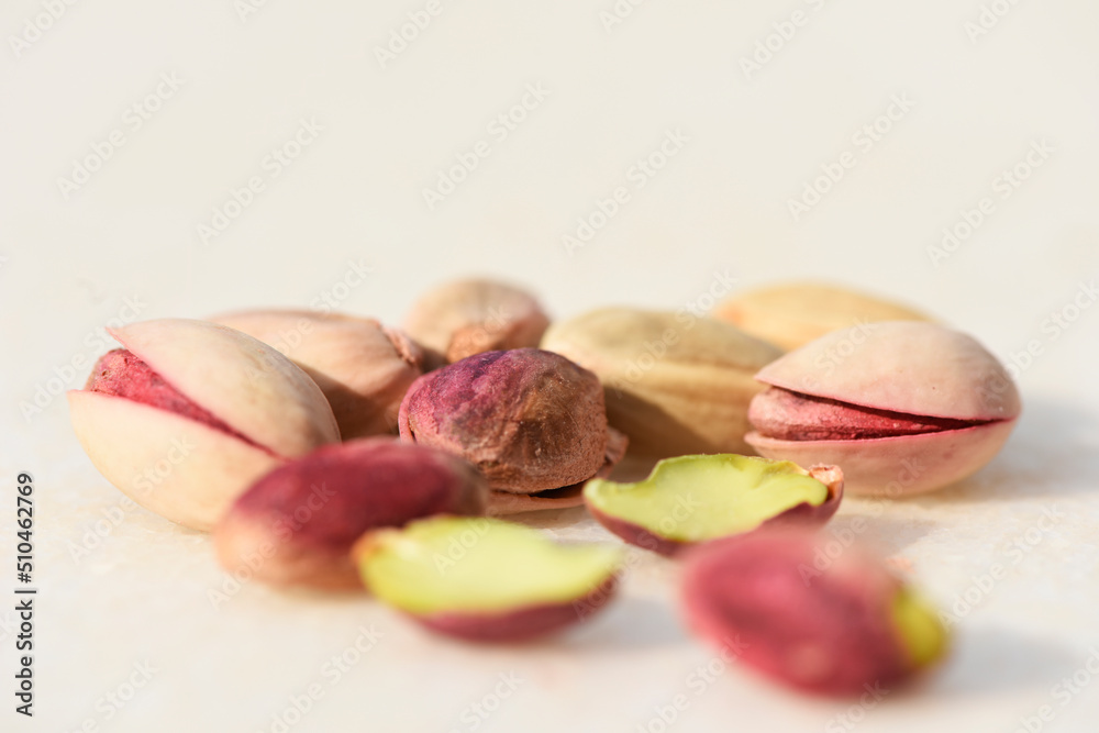 Pink and green pistachio nuts, shelled and unshelled with beautiful colours and soft light Pink and green pistachio nuts, shelled and unshelled with beautiful colours and soft light
