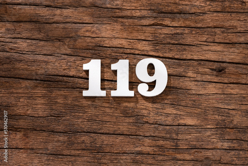 Number 119 in wood, isolated on rustic background