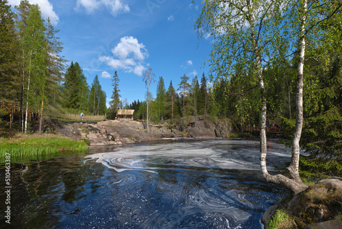 Ruskeala park in Karelia on a sunny summer day: Northern nature, granite stones.