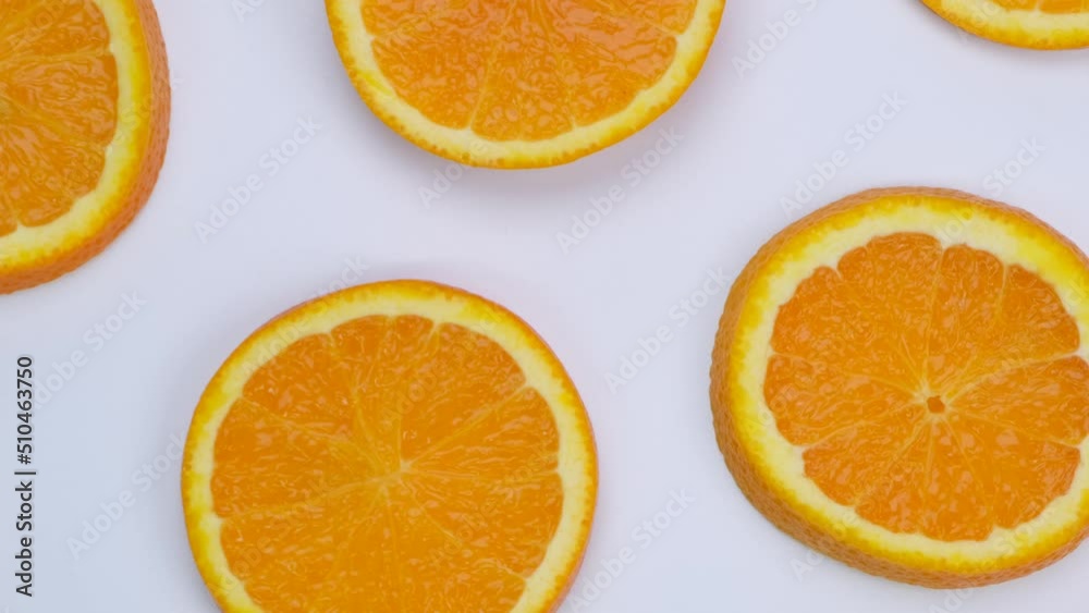 Rotating background with slides of orange on a white background, trendy summer, fruity background Rotating background with slides of orange on a white background, trendy summer, fruity background