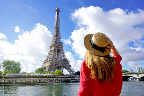 Holidays in Paris. Back view of beautiful fashion girl enjoying view of Eiffel Tower in Paris, France. Summer vacation in Europe. © zigres