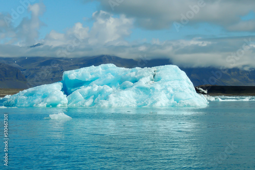 Bright clear blue iceberg floating in the Jokulsarlon lake blue cold water in Iceland 34