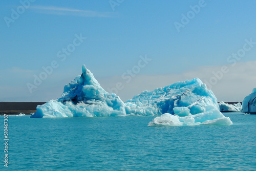 Bright clear blue iceberg floating in the Jokulsarlon lake blue cold water in Iceland 19