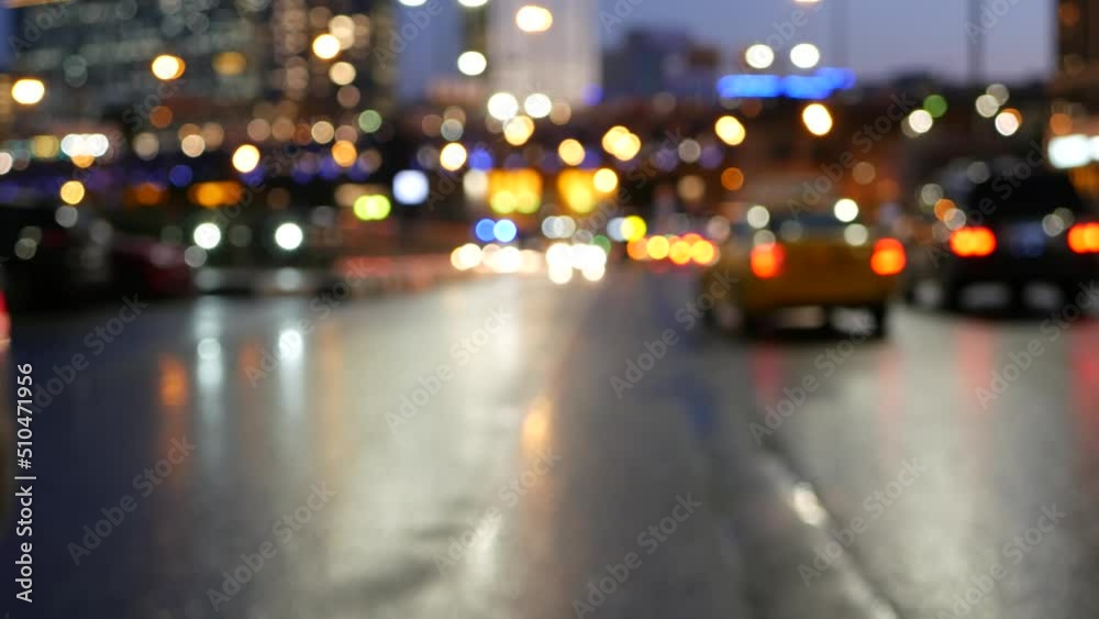 Defocused cars lights on road in twilight, vehicles traffic on megapolis street. Urban downtown, business or financial district of Moscow, Russia. Transport driving, big city life. Yellow taxi cab.