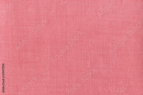 The texture of natural linen fabric is a pleasant natural rich pink shade. Linen napkin. Background of natural coarse fabric.