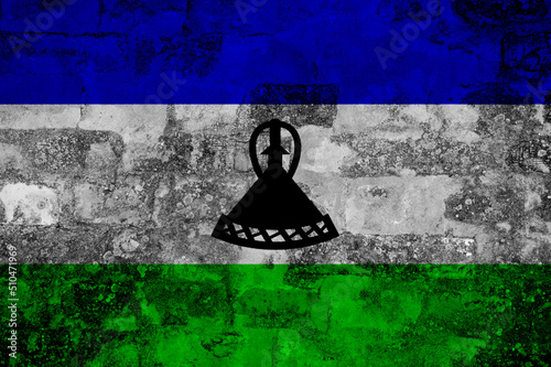 Flag of Lesotho on old grunge wall in background
