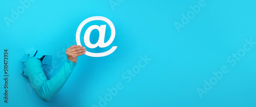 email sign in hand over blue background, panoramic layout
