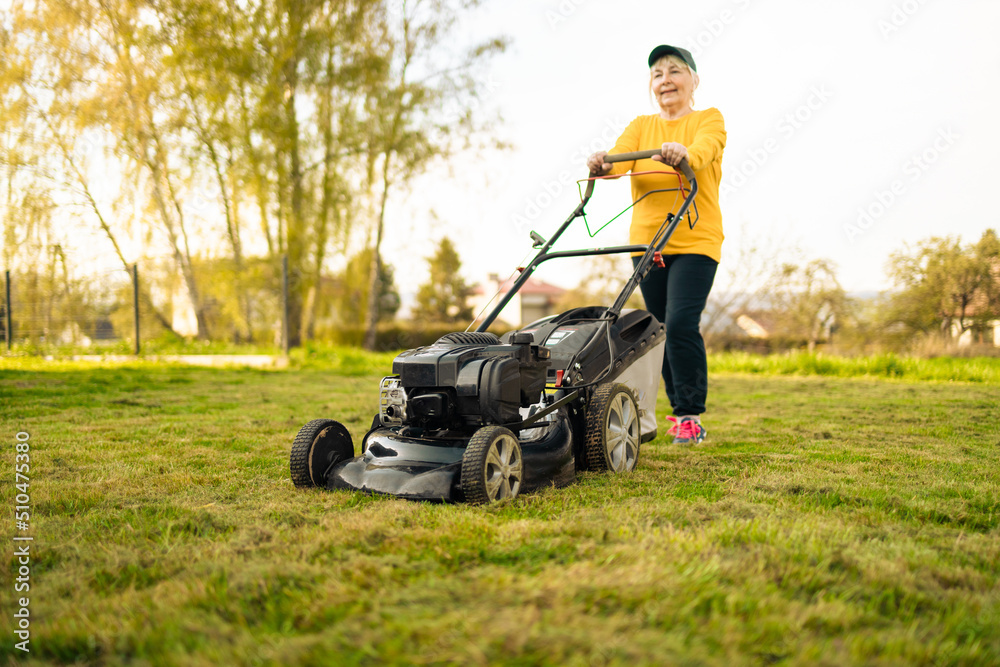 Lawn mover on green grass in modern garden. Machine for cutting lawns.