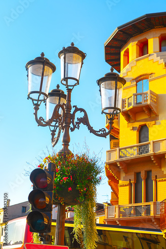 Traffic light and street lamps . Street decor with flowers and lanterns 