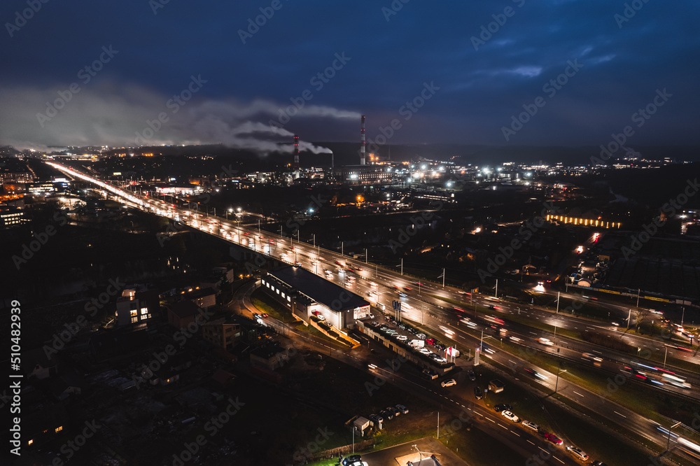 Multi-lane road in the European city Vilnius at night from aerial  perspective