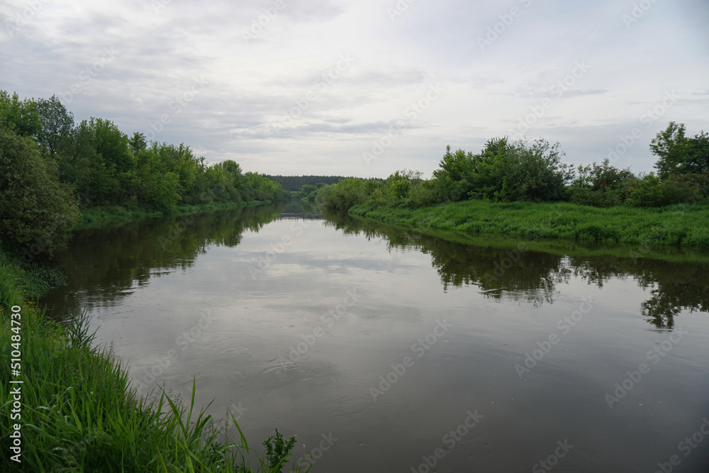 Evening landscape with the last rays of the sun. Morning by the river in summer. Beautiful nature, photo for design Evening landscape with the last rays of the sun. Morning by the river in summer. Beautiful nature, photo for design