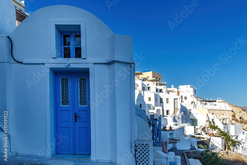 Fototapeta Naklejka Na Ścianę i Meble -  Blue wooden door on the streets of Santorini.