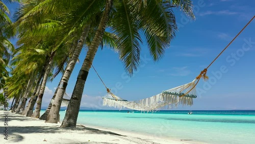 Beautiful tropical island with sand beach and hammock. Panglao, Philippines. Seascape with beautiful beach and palm trees. photo