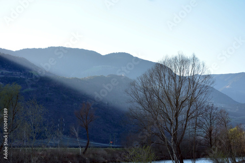 Mountains, trees and the river Etsch, in Vilpian, south Tirol