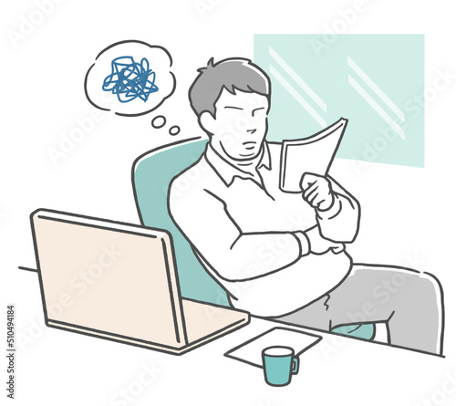 仕事中に書類を見て悩む若いビジネスマン