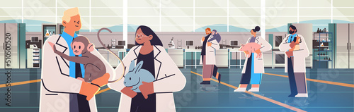 scientists or veterinary workers doing experiments in lab with experimental animals biological genetic engineering research