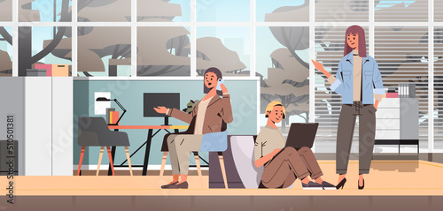 businesspeople using digital gadgets and discussing during meeting teamwork concept