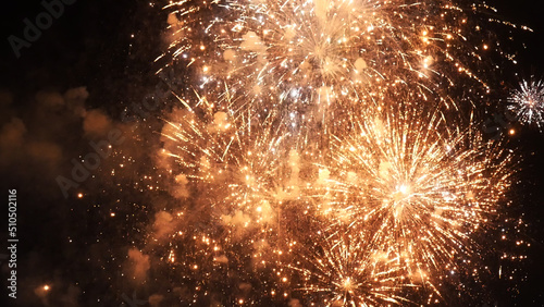 Golden Firework celebrate anniversary happy new year 2023, 4th of july holiday festival. Gold firework in the night time celebrate national holiday. Countdown to new year 2022 gold party time event © aFotostock