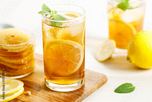 glass of ice lemon tea with mint. © shersor