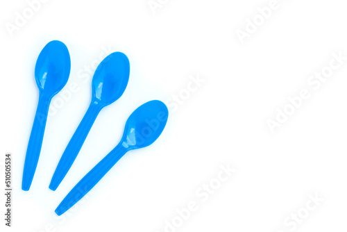 Blue plastic spoons on white background © voranat