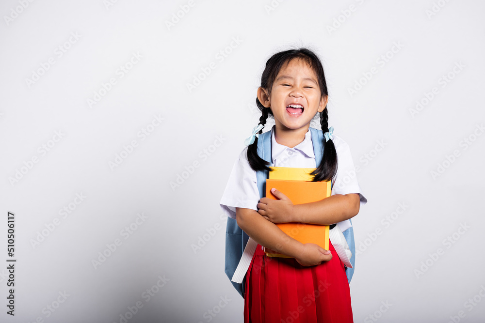 Asian adorable toddler smiling happy wear student thai uniform red skirt stand hold or hugging book in studio shot isolated on white background, Portrait little children girl preschool, Back to school Asian adorable toddler smiling happy wear student thai uniform red skirt stand hold or hugging book in studio shot isolated on white background, Portrait little children girl preschool, Back to school