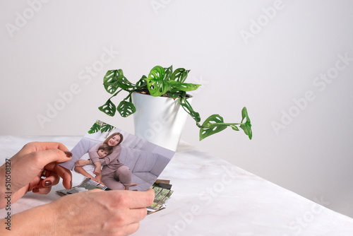 woman sitting at desk and looking at printed photos, remember nostalgia for a day of rest. photography cards, background. Mock up photo