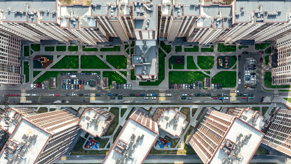 aerial top view of a courtyard of a high-rise residential building with a parking lot
