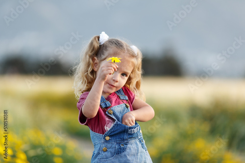 Portrait of happy little girl in a wheat field.
