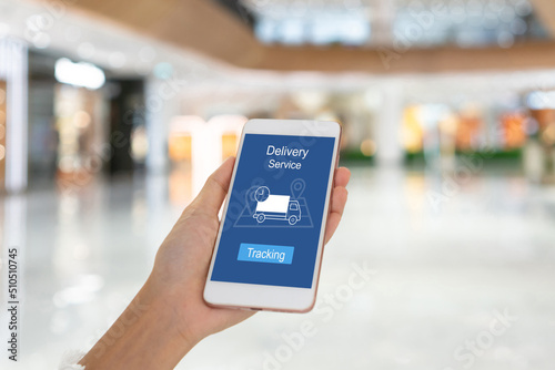 Woman using smartphone with mobile app tracking parcel online to update status and delivery service status. Online shopping, Tracking, delivery concept