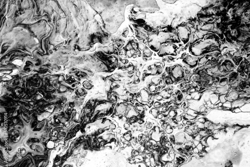 black and white paint spilled onto the canvas, creating an interesting abstract pattern, a pattern of lines, halftones, evoking different associations in your design. liquid art