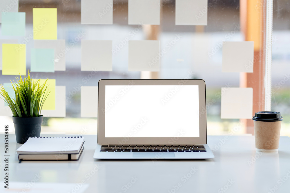 Laptop computer with blank white screen on table in the office. mock up. Laptop computer with blank white screen on table in the office. mock up.