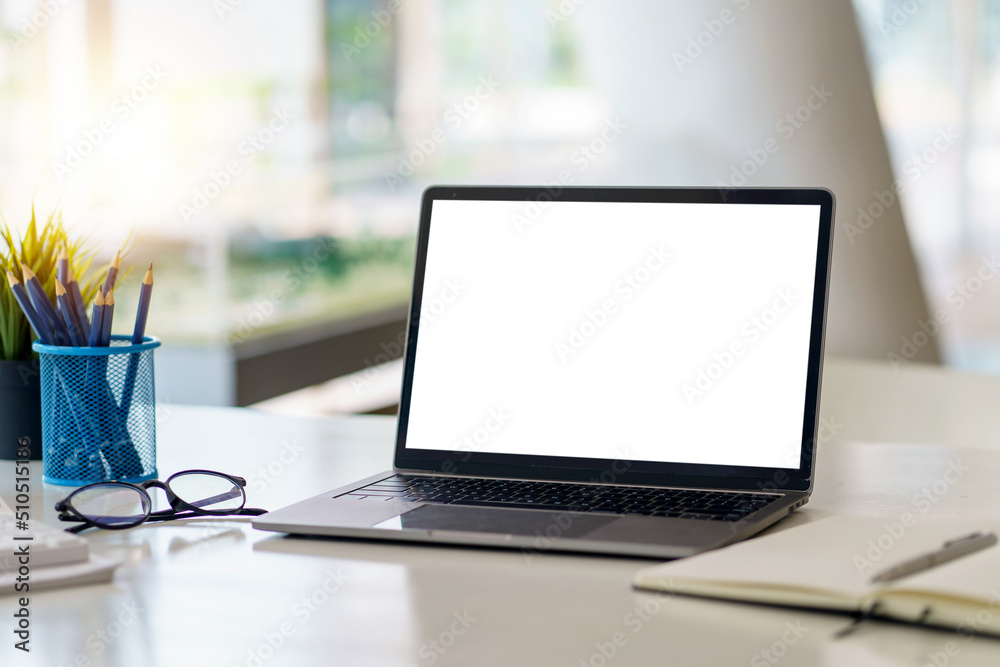 Laptop computer with blank white screen on table in the office. mock up. Laptop computer with blank white screen on table in the office. mock up.
