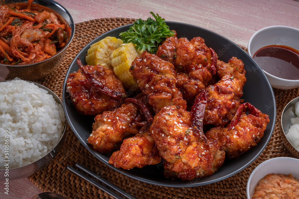 Gang Jeong chicken or crispy and tender Korean fried chicken smothered in a sticky, spicy red sauce Served with kimchi, dipping sauce, rice and sweet corn. Gang Jeong chicken or crispy and tender Korean fried chicken smothered in a sticky, spicy red sauce Served with kimchi, dipping sauce, rice and sweet corn.