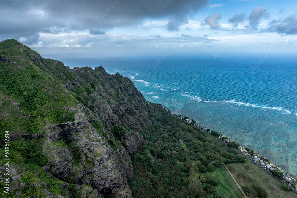 Mountain peaks by the ocean leading to deep valley with clouds above the tops, Oahu Island, Hawaii