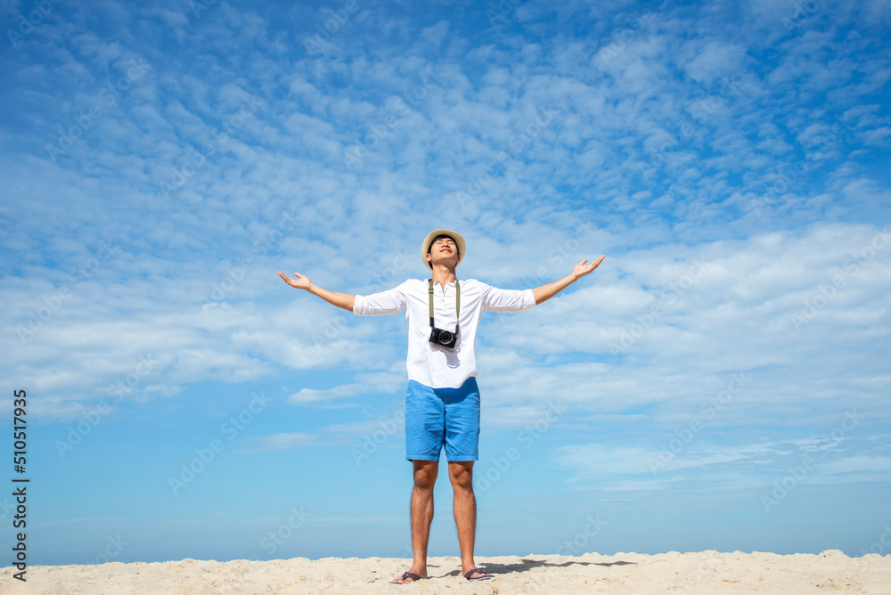 Enjoying life Back side of young man looking at the sea, vacations lifestyle concept Enjoying life Back side of young man looking at the sea, vacations lifestyle concept