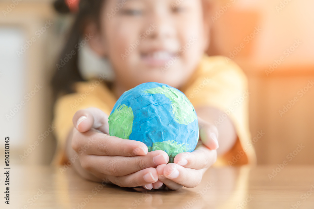 Hands holding earth paper and water paint. Concept of protecting the world from global warming. Sustainability topic to save the world. Hands holding earth paper and water paint. Concept of protecting the world from global warming. Sustainability topic to save the world.