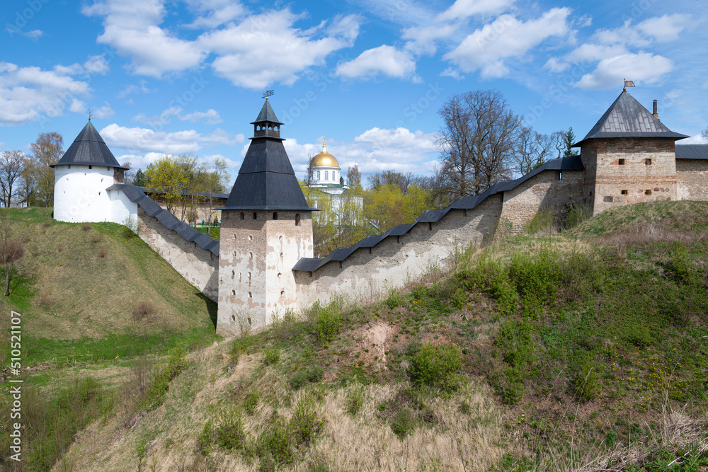 Sunny May day at the ancient walls of the Holy Assumption Pskov-Caves Monastery. Pechory, Pskov region. Russia