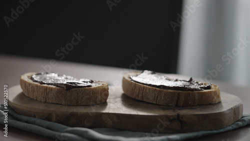 chocolate spread on ciabatta slice on olive board