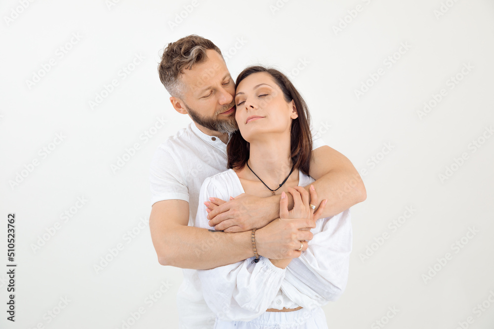 Man and woman, family stand together, embracing. Trust and love relationship. Male behind female, celebrate. Copy space Man and woman, family stand together, embracing. Trust and love relationship. Male behind female, celebrate. Copy space