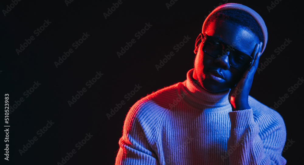 Sad man. Support banner. Mental health. Neon light header. Frustrated depressed guy in vivid red glow isolated on black empty space background. Sad man. Support banner. Mental health. Neon light header. Frustrated depressed guy in vivid red glow isolated on black empty space background.